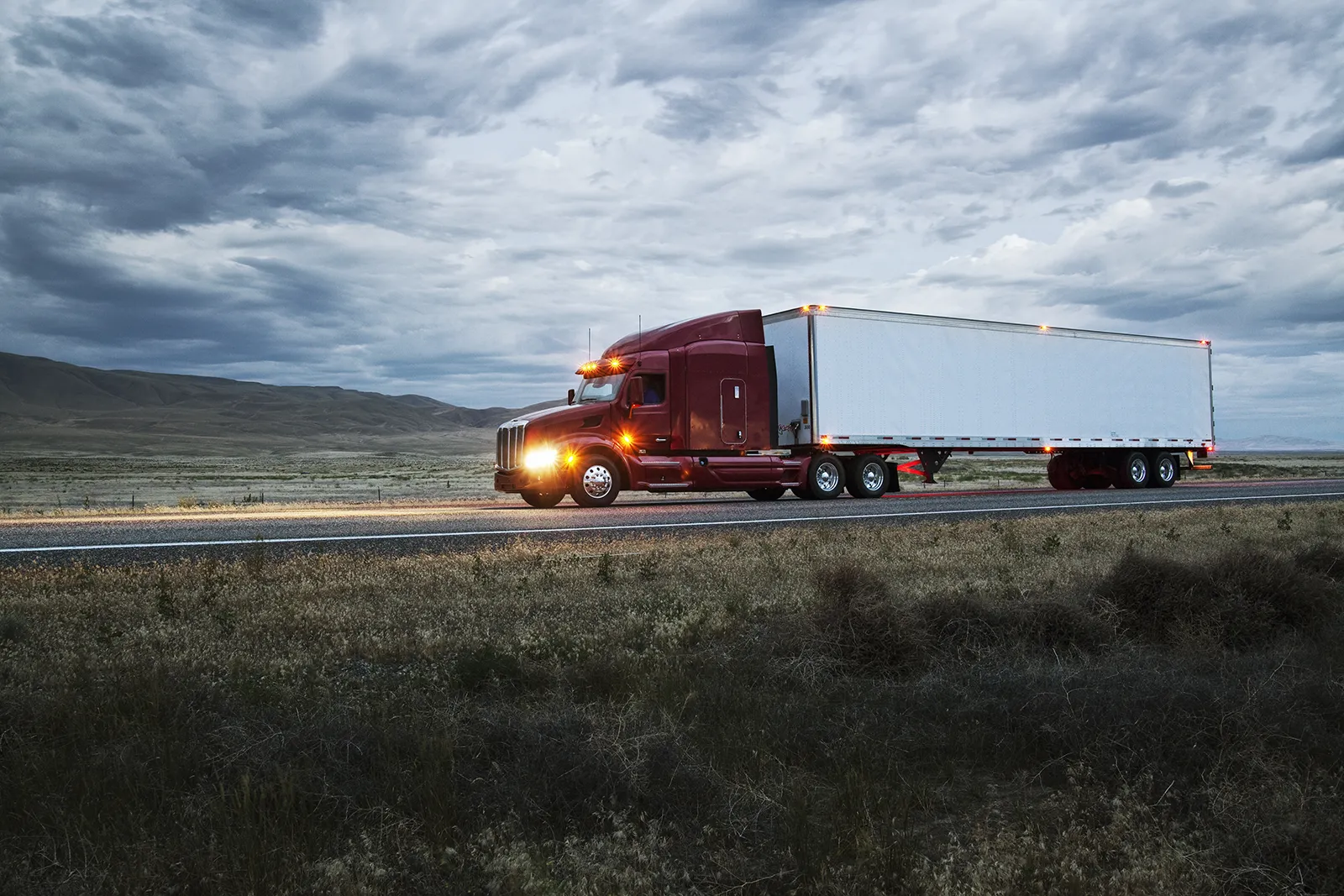 truck-on-a-highway-through-the-grasslands-area-of-2023-11-27-05-02-05-utc