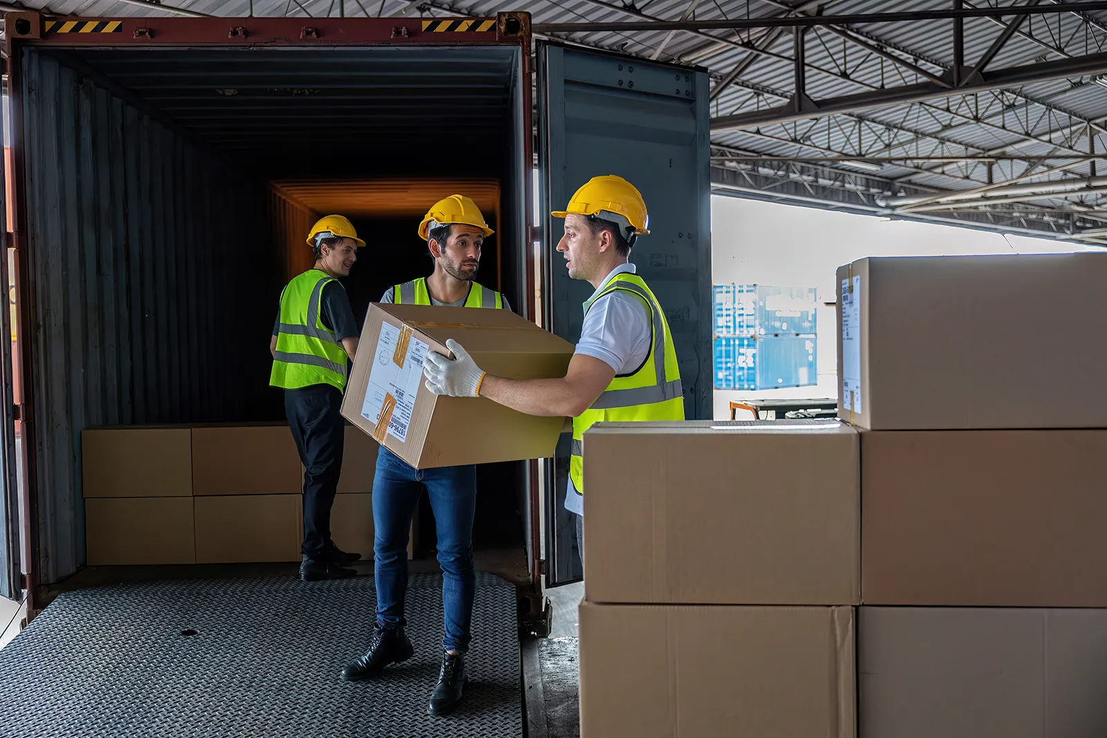 3-workers-hand-carry-carton-box-take-from-40-feet-2024-10-18-04-35-54-utc
